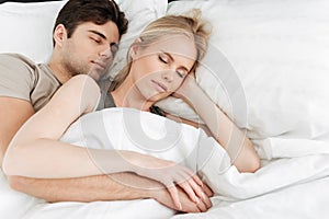 Portrait of calm handsome couple sleeping in bed