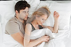 Portrait of calm handsome couple sleeping in bed