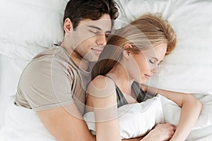 Portrait of calm handsome couple sleeping in bed