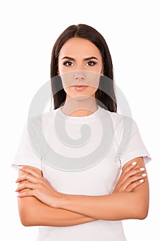 Portrait of calm minded young woman with crossed hands