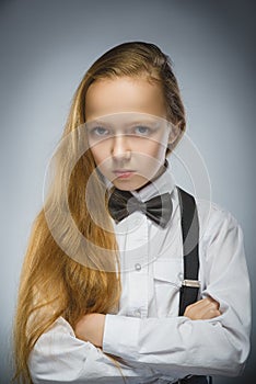 Portrait of calm and mistrust girl isolated on gray background. Normal human emotion, facial expression. Closeup