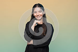 Portrait of calmly smiling multiracial woman 25s against a colorful background