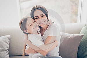 Portrait of candid cute sweet two people lovely mom and her kid girl hug mother cuddle enjoy spend free time together