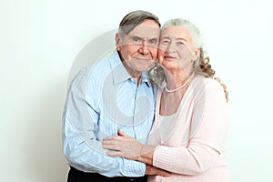 Portrait of candid senior couple enjoying their retirement. Affectionate elderly couple with beautiful beaming friendly smiles pos