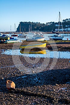 A portrait capture of a collection of boats lit by afternoon sun at Teignmouth Devon