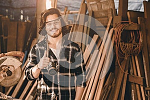 Portrait Carpenter man wood worker builder handsome smart thumbs up smiling for good job or done hand like work