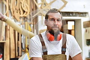 Portrait of a carpenter in work clothes and hearing protection i