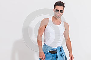 Portrait of casual man wearing undershirt standing in spotlight