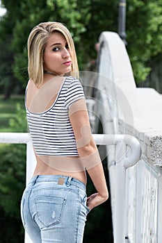 Portrait of casual woman looking back next to bridge