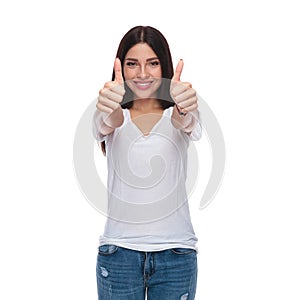 Portrait of casual woman making ok sign whilte standing