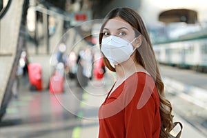 Portrait of casual woman waiting train with KN95 FFP2 protective mask at train station