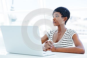 Portrait of a casual young african businesswoman using laptop computer