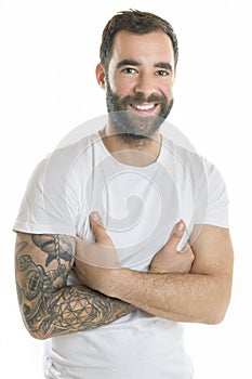 portrait of casual young man with beard and tattoo on white background