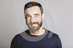 portrait of casual young man with beard white background