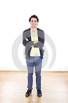 Portrait of casual young man standing with arms crossed