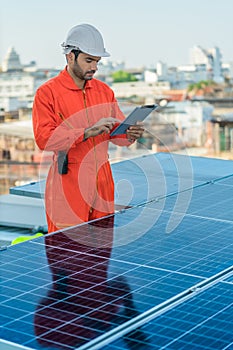 Alternative energy engineer checking energy power performace of solar power system photo