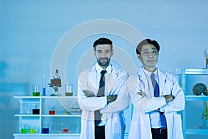 Portrait of caucasian and asian in modern scientific laboratory working together