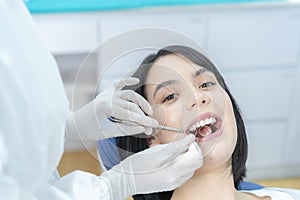 Portrait of Caucasian beautiful girl patient smile while receive treatment from professional dentist doctor for oral care check up
