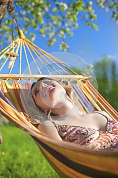 Portrait of Caucasian Blond Lady Resting in Hummock During Spring Time