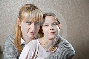 Portrait of caucasian blonde woman with her beautifull daughter.