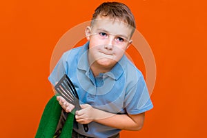 Portrait of a Caucasian boy. The boy holds a paper towel, the other hand used to towel. Housewives concept