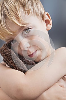Portrait of Caucasian boy wiping his face with towel