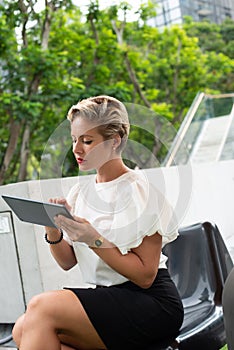 Portrait Caucasian business woman using mobile tablet