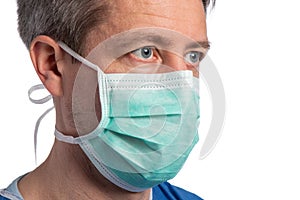 Portrait of a caucasian doctor wearing a protection mask on a white background