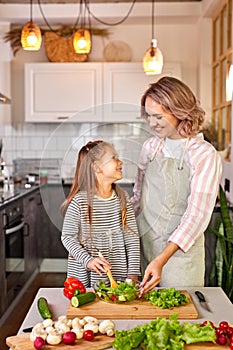 portrait of caucasian family mother with daughter cooking together