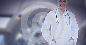 Portrait of caucasian female doctor smiling against surgical light in background