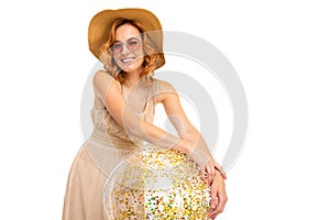 Cheerful woman with fair red hair in beautiful dress holds a ball, picture isolated on white background