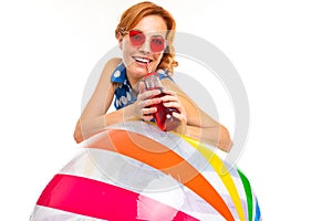 Cheerful woman with fair red hair holds a ball, picture isolated on white background