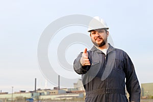 Portrait of caucasian foreman with outstetched hands standing in construction site background.