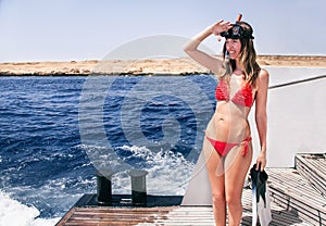 Portrait of caucasian girl at the yacht with snorkeling mask an