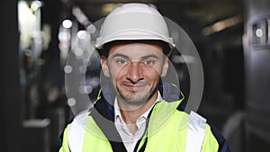 Portrait of caucasian heavy industry engineer worker posing confident to camera wearing hardhat and uniform. Business