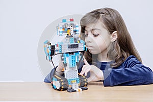 Portrait of Caucasian kid constructing a robot