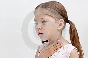Child holding hand on throat photo
