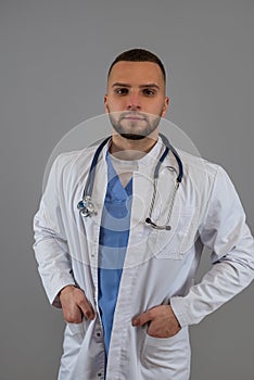 Portrait of caucasian male doctor, general practitioner in white coat isolated