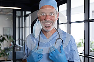 Portrait of caucasian male doctor standing looking at the camera and smiling