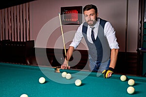 portrait of caucasian male standing next to billiards table