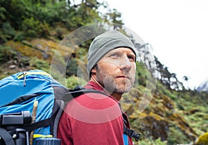 Portrait of caucasian man with backpack in Makalu Barun Park route near Khare. Mera peak climbing acclimatization active walk.