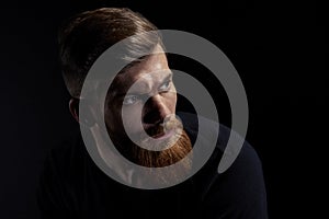 Portrait of caucasian man with big beard in black T-shirt Horizontal