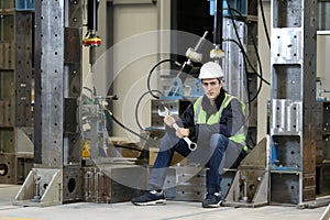 Portrait of a Caucasian man , factory engineer in work clothes controlling the work process at the helicopter manufacture.