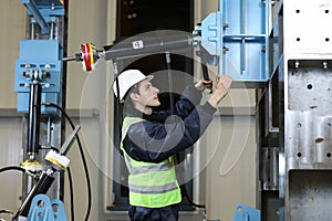 Portrait of a Caucasian man , factory engineer in work clothes controlling the work process at the helicopter manufacture.