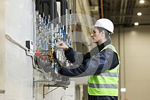 Portrait of a Caucasian man , factory engineer in work clothes controlling the work process at the helicopter manufacture.