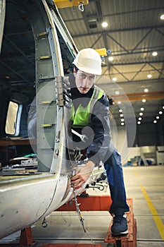 Portrait of a Caucasian man , factory engineer in work clothes controlling the work process at the helicopter manufacturer.