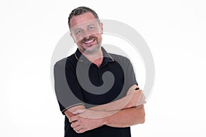 Portrait of caucasian mature middle-aged man in black shirt looking at camera and smiling isolated in white background