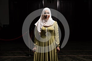 Portrait of a Caucasian muslim woman wearing the Islamic Long Hijab Khimar inside a mosque