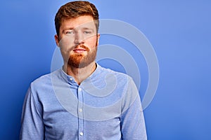 Portrait of caucasian redhead man looking at camera