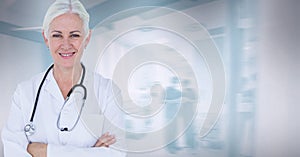 Portrait of caucasian senior female doctor smiling against hospital in background